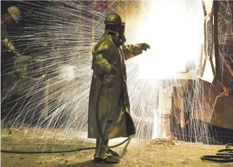  ??  ?? An employee at German steel producer Salzgitter. The EU has responded angrily to US plans to tax metal imports Getty