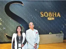  ?? Clint Egbert/Gulf News ?? Jyotsna Hegde, president (left) and P.N.C. Menon, founder and chairman of Sobha Realty in front of the new Sobha branding at Cityscape Global at the DWTC yesterday..