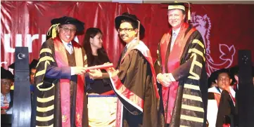  ??  ?? Raj (centre) receives his scroll from Abang Johari, witnessed by Prof Pollaers (right). — Photos by Mohd Rais Sanusi