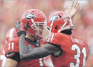  ?? JOHN BAZEMORE / AP ?? Former Georgia quarterbac­k Aaron Murray would be reunited with several former Bulldogs if he joins the Bengals, including receiver A.J. Green, with whom he connected for nine touchdowns as a freshman in 2010.