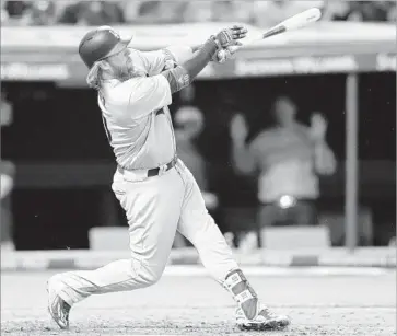  ?? Tony Dejak Associated Press ?? JUSTIN TURNER of the Dodgers hits a double against Cleveland starter Corey Kluber in the sixth inning.