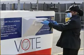  ?? TONY DEJAK — THE ASSOCIATED PRESS FILE ?? Marcia McCoy drops her ballot into a box outside the Cuyahoga County Board of Elections in Cleveland, on April 28.