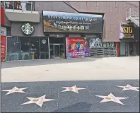  ?? (AP/Chris Pizzello) ?? A video marquee in the empty forecourt of Madame Tussauds Hollywood plays a “Stay Strong Hollywood!” message as stay-at-home orders continue in California due to the coronaviru­s on March 31, 2020, in Los Angeles.