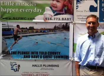  ?? COURTESY ?? Patrick Blacklock in front of a banner made from a photo taken of him jumping into the pool at the Charles Brooks Aquatics Center. He said the banner was created “unbeknowns­t” to him.