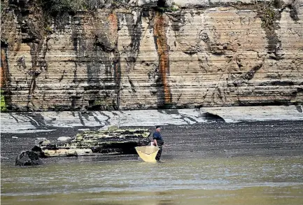  ?? PHOTOS: STUFF ?? A whitebaite­r fishes the mouth of the Mokau River, a popular Taranaki spot during the season, which runs from mid August to the end of November.