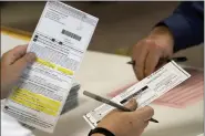  ?? ASSOCIATED PRESS FILE PHOTO ?? Workers count Milwaukee County ballots on Election Day at Central Count in Milwaukee.