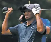  ?? JEFF ROBERSON/ASSOCIATED PRESS ?? Tiger Woods was in thick grass and at the bottom of a pond early on Thursday before rallying to salvage a 70.