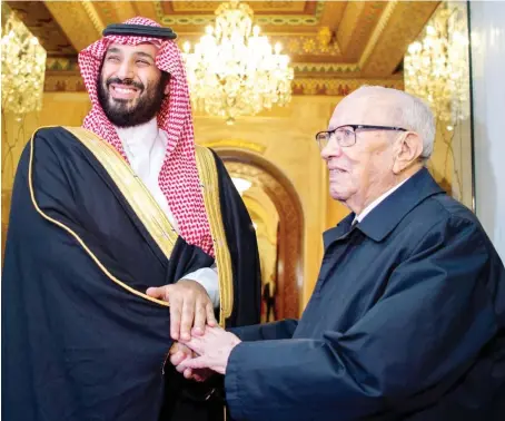  ?? Crown Prince Mohammed bin Salman is welcomed by Tunisian President Beji Caid Essebsi at the presidenti­al palace in Carthage on Tuesday. ??