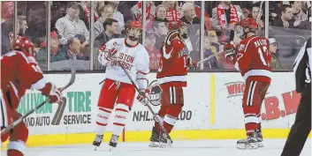  ?? STAFF PHOTO BY MATT WEST ?? BIG NIGHT: Harvard’s Nathan Krusko (13), the tournament MVP, celebrates his secondperi­od goal with Sean Malone (17) during last night’s win against BU in the Beanpot final.