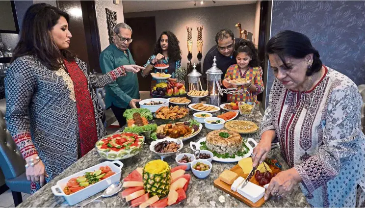  ??  ?? Tantalisin­g Pakistani and Egyptian dishes are served when the family breaks its fast in Dr Sobia’s (far left) home throughout Ramadan. — Photos: RAJA FAISAL HISHAN/The Star