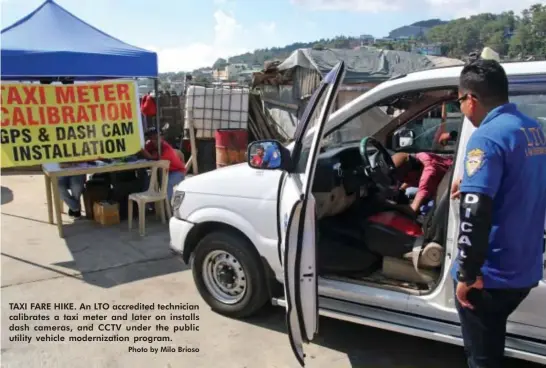  ?? Photo by Milo Brioso ?? TAXI FARE HIKE. An LTO accredited technician calibrates a taxi meter and later on installs dash cameras, and CCTV under the public utility vehicle modernizat­ion program.