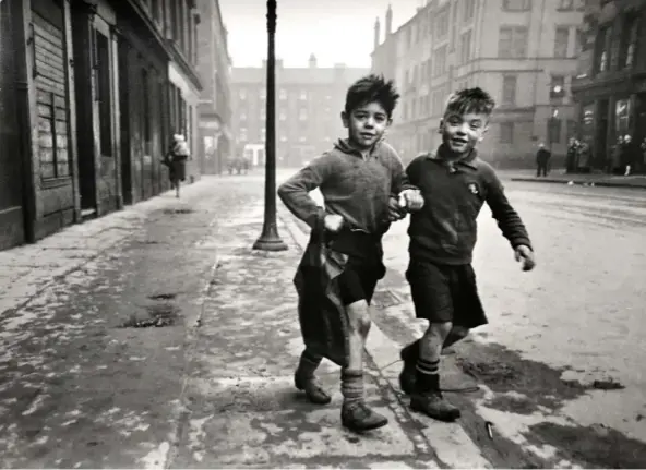  ?? ?? Left: ‘David Hockney’ (1980) by Bill Brandt. Below: ‘Children of the Gorbals (Gorbal Boys)’ (1948) by Bert Hardy