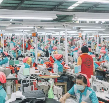  ?? Bloomberg ?? Clockwise from left: Indonesian President Joko Widodo on a factory visit; Sritex clothing factory in Solo; Pan Brothers factory in Java