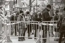  ?? Hiroko Masuike / New York Times ?? People wait to get the coronaviru­s vaccine in Queens. Optimism about vaccines and the sudden growth in options trading combined with buyer optimism make for a market-moving force.