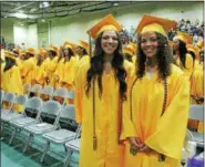  ??  ?? Sabrina Wolfe (left) and Madelin Brown (right) during Troy High School’s 2017 commenceme­nt ceremony on Sunday at Hudson Valley Community College in Troy.