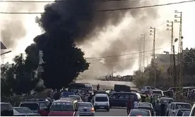  ?? Photograph: AP ?? Black smoke rises from the scene where a fuel tank exploded in Tleil village, north Lebanon.