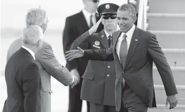  ?? — AP ?? US President Barack Obama shakes hands with Rhode Island Gov. Lincoln Chafee shortly after arriving at T. F. Green Airport in Warwick, Rhode Island.