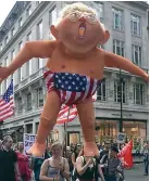  ??  ?? Baby blimp: At large in London Sign of the times: A protester in Glasgow expresses his views