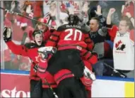  ?? FRANK GUNN — THE CANADIAN PRESS VIA AP ?? Canada players celebrate a goal by forward Tyler Steenberge­n against Sweden during the third period of the title game of the IIHF world junior hockey championsh­ips, Friday in Buffalo, N.Y.
