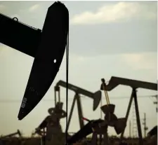  ?? AP FILE ?? OIL! The U.S. Geological Survey said on Thursday that portions of the Permian Basin along the Texas-New Mexico state line could hold even more promise of oil and natural gas. Above, pumpjacks work in a field near Lovington, N.M.