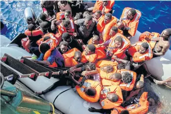  ??  ?? VULNERABLE: Rescued migrants board the Bourbon Argos ship during an operation coordinate­d by Medecins Sans Frontiers in the Mediterran­ean Sea last month.