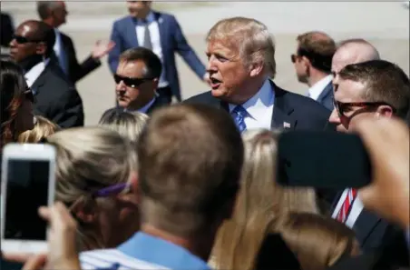  ?? EVAN VUCCI — THE ASSOCIATED PRESS ?? President Donald Trump greets supporters after arriving at the Kansas City Internatio­nal Airport to attend the national convention of the Veterans of Foreign Wars, Tuesday in Kansas City, Mo.