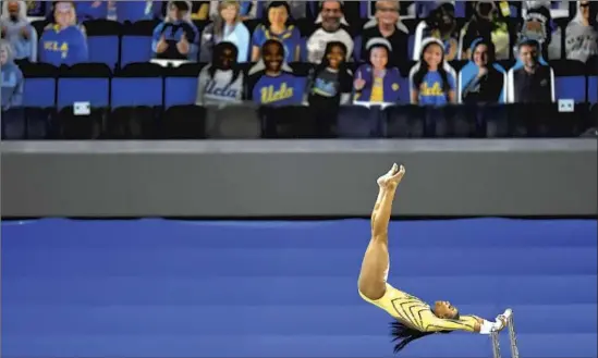  ?? Photograph­s by Wally Skalij Los Angeles Times ?? AFTER SEEING the Black Lives Matter protests last summer, Nia Dennis, on the uneven bars, decided to send her social justice message on the gymnastics floor.