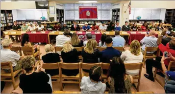  ?? RICHARD GRAULICH / THE PALM BEACH POST ?? Students prepare to sign their documents during national signing day ceremonies at Dwyer on Wednesday. Nearly half of the school’s football players who signed Wednesday will stay in Florida.