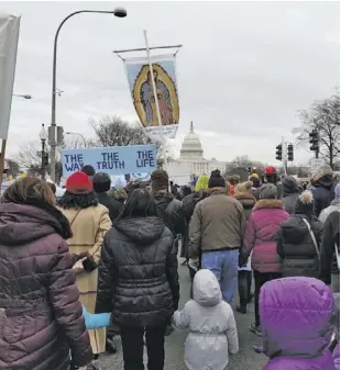  ??  ?? Parishione­rs of St. Peter Catholic Church at the March for Life.