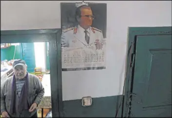  ?? Darko Vojinovic The Associated Press ?? A picture of former Yugoslav communist leader Josip Broz Tito adorns the house of Uros Trainovic in Blagojev Kamen, Serbia. The village now has just eight residents.