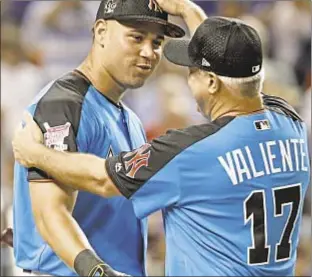  ??  ?? Gary Sanchez gets congratula­tions from practice pitcher Danilo Valiente after impressive first round but it is Yankee teammate Aaron Judge (opposite l.) who swings into All-Star spotlight with dazzling display of power and distance to claim Derby...