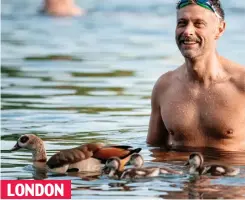  ?? ?? LONDON
Feathered friends: A swimmer takes a dip in Hyde Park