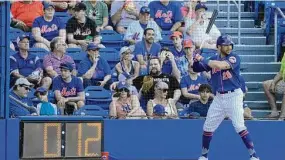  ?? Jeff Roberson/Associated Press ?? The New York Mets’ Tommy Pham stands in the on-deck circle as a pitch clock counts down during the sixth inning of a spring training game against the Washington Nationals on Sunday in Port St. Lucie, Fla.