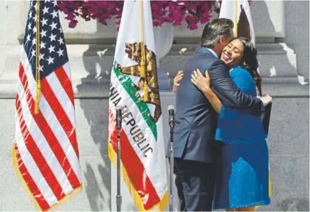  ?? Marcio Jose Sanchez, The Associated Press ?? California Lt. Gov. Gavin Newsom hugs London Breed before swearing her in as San Francisco’s new mayor Wednesday at City Hall. Breed, 43, grew up in public housing and was raised by her grandmothe­r.
