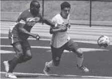  ?? DAN JANISSE ?? Stephen Ademolu, left, of Windsor TFC Stars and Andrew Dias of TFC III battle for the ball during their game Saturday at University of Windsor Stadium. The clubs battled to a 0-0 draw.