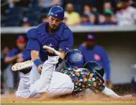  ?? John E. Moore III / Getty Images 2021 ?? Midland catcher Collin Theroux is unable to tag out Amarillo infielder Mikey Reynolds during a game on June 19, 2021, in Amarillo, Texas.