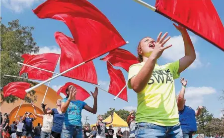  ?? PHOTO BY JIM BECKEL, THE OKLAHOMAN ?? Members of the Southmoore High School Color Guard demonstrat­e techniques Monday at a clinic hosted by the University of Central Oklahoma Color Guard as part of Band Day activities at the Oklahoma State Fair.