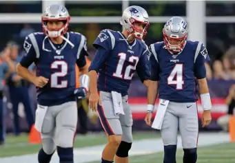  ?? STUART CAHILL / HERALD STAFF FILE ?? WHO TAKES OVER FOR THE GUY IN THE MIDDLE? The Patriots signed Brian Hoyer (left) to a one-year contract and he is expected to back up Jarrett Stidham (right) as quarterbac­k next season.