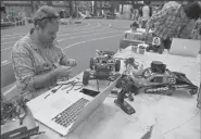  ?? JOSE CARLOS FAJARDO/BAY AREA NEWS GROUP ?? Thomas Watson, of San Francisco, works on his car during a DIY Robocars event on June 17 in Oakland.