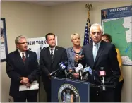  ?? GLENN GRIFFITH — MEDIANEWS GROUP FILE ?? Rensselaer County Clerk Frank Merola lends his support to Sen. Jim Tedisco’s opposition to the governor’s license plate proposal at a press conference earlier this month. Standing behind him, left to right are Sen. Jim Tedisco, Saratoga County Clerk Craig Hayner, Assemblywo­man Mary Beth Walsh, and partially hidden, Herkimer County Clerk Sylvia Rowan.