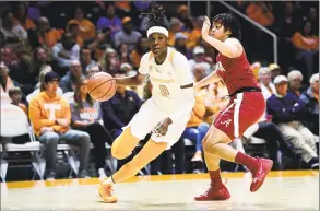  ?? Calvin Mattheis / Associated Press ?? Tennessee guard/forward Rennia Davis (0) dribbles around Alabama guard Megan Abrams (1) during an NCAA women’s basketball game in Knoxville, Tenn. on Jan. 20. Tennessee defeated Alabama 65-63. Coach Pat Summitt made the Lady Volunteers a household name decades ago.