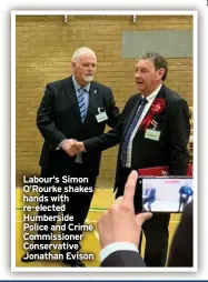  ?? ?? Labour’s Simon O’Rourke shakes hands with re-elected Humberside Police and Crime Commission­er Conservati­ve Jonathan Evison