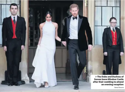  ?? Steve Parsons ?? > The Duke and Duchess of Sussex leave Windsor Castle after their wedding to attend an evening reception