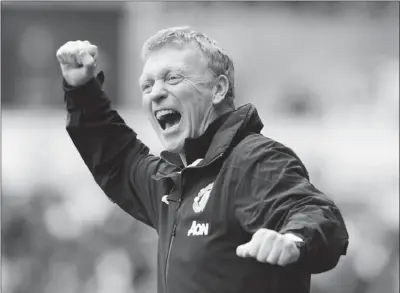  ?? REBECCA NADEN / REUTERS ?? Manchester United manager David Moyes celebrates after seeing his team score during a 4-1 victory over Swansea City in their English Premier League match in Swansea on Saturday.