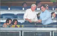  ?? JULIE JACOBSON/AP PHOTO ?? Indiana Gov. Mike Pence, second from right, picks up empty plates as he prepares to leave the owner’s box Friday night at Yankee Stadium during a baseball game between the New York Yankees and the Boston Red Sox with his wife, Karen, left, and daughter...