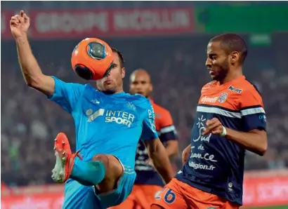  ??  ?? Marseille’s Benoit Cheyrou vies with Montpellie­r’s Yassine Jebbour during their match on Thursday. —