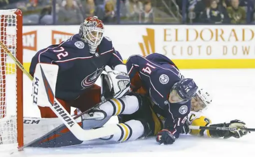  ?? Jay LaPrete/Associated Press ?? Sidney Crosby, right, and Columbus’ Dean Kukan, center, collide with Blue Jackets goalie Sergei Bobrovsky in the first period Friday.