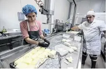  ?? Photo: Reuters ?? Pantelis Panteli and a worker prepare halloumi on his farm in Cyprus
