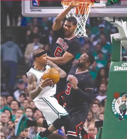  ??  ?? Celtics guard Isaiah Thomas has been hounded all series by Bulls defenders, including Dwyane Wade ( 3) and Cristiano Felicio. | AP