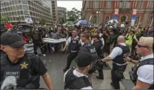  ??  ?? Metro Police and Secret Service personnel are forced back by counter-protesters outside of the Pennsylvan­ia Avenue security barrier on 17th Street while attempting to escort attendees of the “Unite the Right 2” rally from Lafayette Park in Washington, on Sunday. CRAIG HUDSON/CHARLESTON GAZETTE-MAIL VIA AP